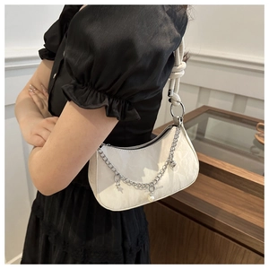 Detail of hobo bag with silver chain, star pearls and braided knot shoulder strap
