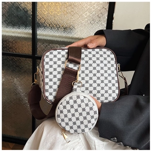 Retro messenger bag with wide shoulder strap and detachable coin purse shown in hand