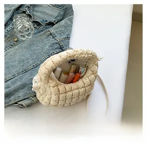 Mini quilted tote bag capacity showing interior with phone and lipsticks inside