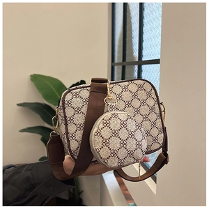 Detail view of the vintage floral crossbody bag with wide strap and round coin purse
