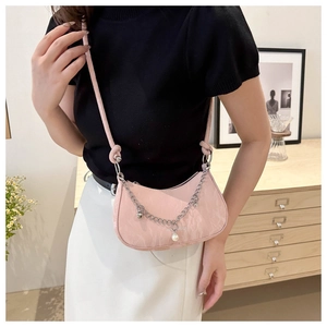Detail of pink jacquard hobo bag featuring silver chain and pearl charm detail