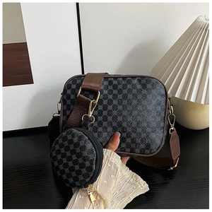 Detail of square crossbody bag with mini round coin purse and wide brown strap