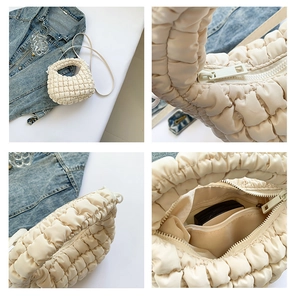 Detail view of cream pleated tote bag showing smooth zipper and spacious inner pocket