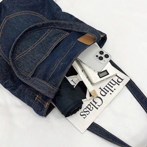 Large capacity navy denim tote bag with orange stitching and multi-pocket interior storage