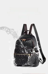 Close-up of waterproof woven black leather backpack with splashing water droplets