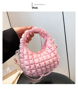 Detail of pink cloud-shaped tote bag with quilted bubble texture and adjustable strap
