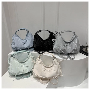 Detailed display of fashionable pleated handbags with bow accents in five various colors