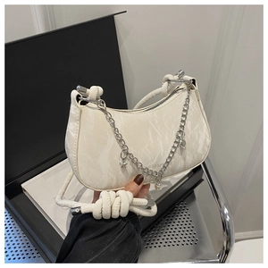 Close-up of marble pattern half-moon shoulder bag with silver charms and rope strap