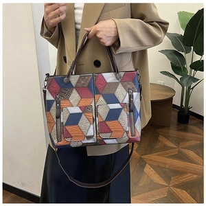 Chic tote bag featuring vintage geometric cube patterns and multiple front zip pockets