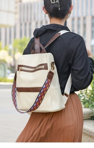 Detail of off-white PU leather backpack with ethnic woven strap and geometric stitching