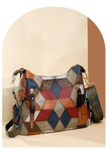 Detail of color-block geometric tote with ethnic style embroidered wide shoulder strap