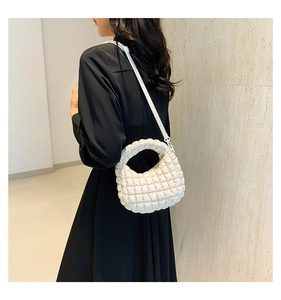 Detail of white bubble textured mini tote bag with adjustable shoulder strap for women