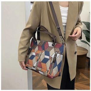 Detail of colorful 3D geometric tote bag with leather texture and adjustable strap