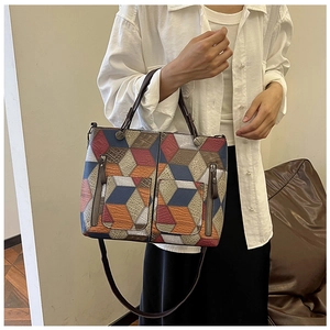 Detail of colorful geometric 3D pattern tote bag with dual zipper pockets for women
