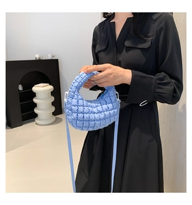 Detailed view of light blue quilted mini tote bag showing soft nylon texture and stitching