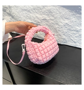 Detail of pink bubble quilted tote bag with soft texture and puffy handle design