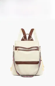 Front view of white PU leather backpack featuring geometric patterns and ethnic straps