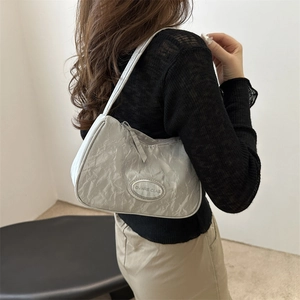 Silver wrinkled texture underarm bag with crescent shape and metallic logo plate