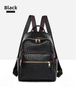 Detail shot of black woven leather backpack featuring brown handle and gold-tone hardware