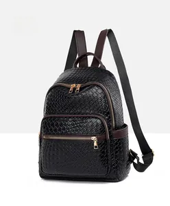 Close-up of black woven texture and brown leather trim on a stylish fashion backpack