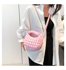 Close-up of pink puffy quilted mini tote bag featuring soft square textured fabric finish