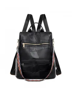 Front view of black lychee grain leather backpack with colorful ethnic shoulder strap