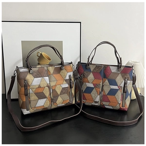 Detail of 3D geometric pattern tote bag with lychee texture and dual handles