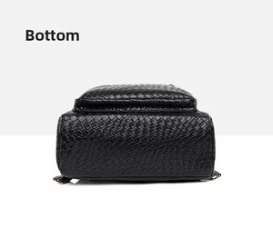 Detailed view of the black woven leather backpack showing the durable flat bottom base