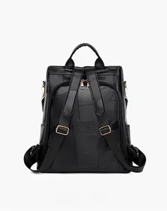 Detail view of the black leather backpack's back with anti-theft zipper and adjustable straps