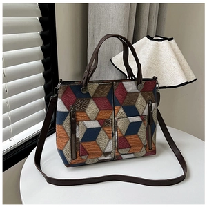 Close-up of geometric multi-color patchwork tote bag with 3D litchi texture and dual straps