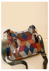 Detail of vintage patchwork leather tote with embossed textures and ethnic style strap