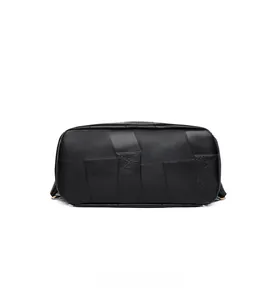 Detailed bottom view of black PU leather backpack showing reinforced patchwork stitching