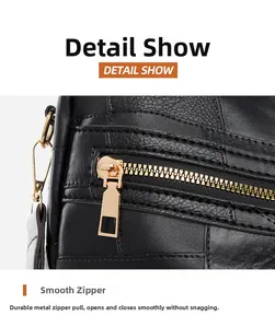 Detail of smooth gold zipper hardware and embossed texture on black leather backpack