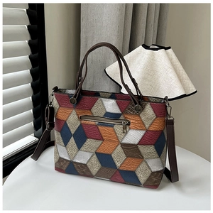 Detail of colorful geometric leather patchwork tote bag with 3D diamond pattern