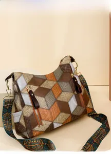 Close-up of retro color-block tote with geometric patterns and ethnic wide shoulder strap