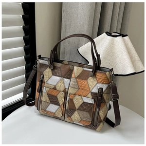 Detail view of multicolored patchwork tote bag with mixed crocodile and snake textures