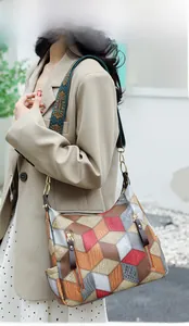 Detail of multi-color 3D geometric pattern handbag with lychee texture leather finish