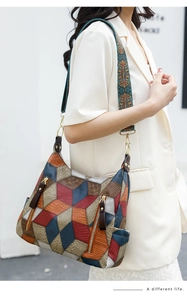 Detail of colorful patchwork leather tote bag with ethnic style wide woven shoulder strap