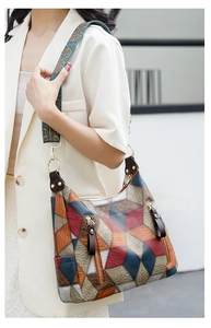 Detail of multi-color leather patchwork tote with ethnic embroidered wide shoulder strap
