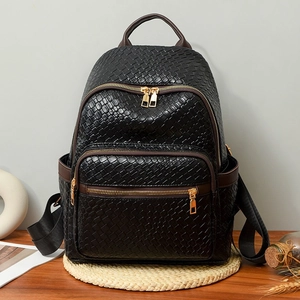 Fashionable black woven faux leather backpack with gold zippers and brown trim accents