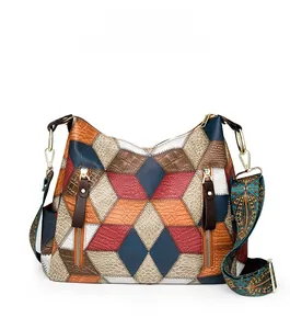 Detail of vintage patchwork tote with bohemian strap and multi-texture leather panels