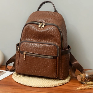 Dark brown woven faux leather backpack with multiple zipper pockets and adjustable straps