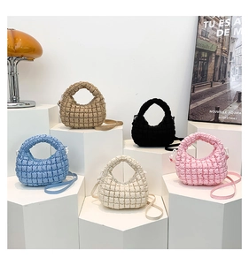 Detailed display of five quilted puffer mini tote bags in various pastel colors