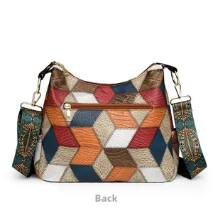 Detail of bohemian patchwork leather bag with lizard texture and rear zipper pocket