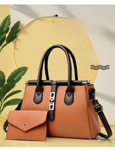 Detail of lychee pattern cowhide leather tote and envelope wallet set in orange brown
