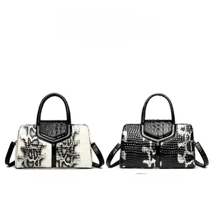 Detail view of snakeskin pattern handbag and black crocodile texture shoulder bag with gold hardware