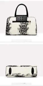 Detail view of snakeskin pattern handbag with back zipper pocket and protective base studs