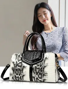 Close-up of dual-texture snakeskin and crocodile pattern on monochrome shoulder bag