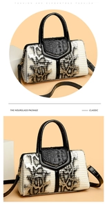 Detailed close-up of faux snakeskin texture and golden metal hardware on a cream tote bag