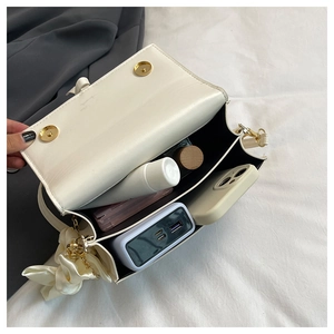 Internal view of cream crossbody bag showing double compartments and daily essentials